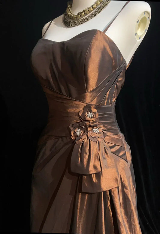 Full length vintage A-line bronze prom dress with spaghetti straps.