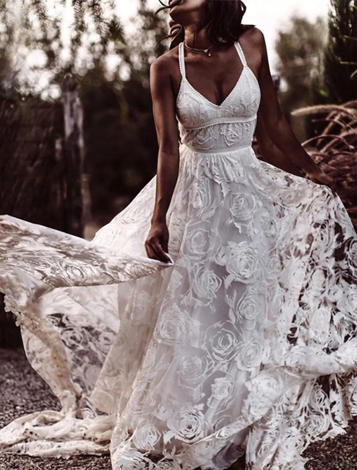 Boho A-Line V-Neck wedding dress with open back and lace appliques, back view.