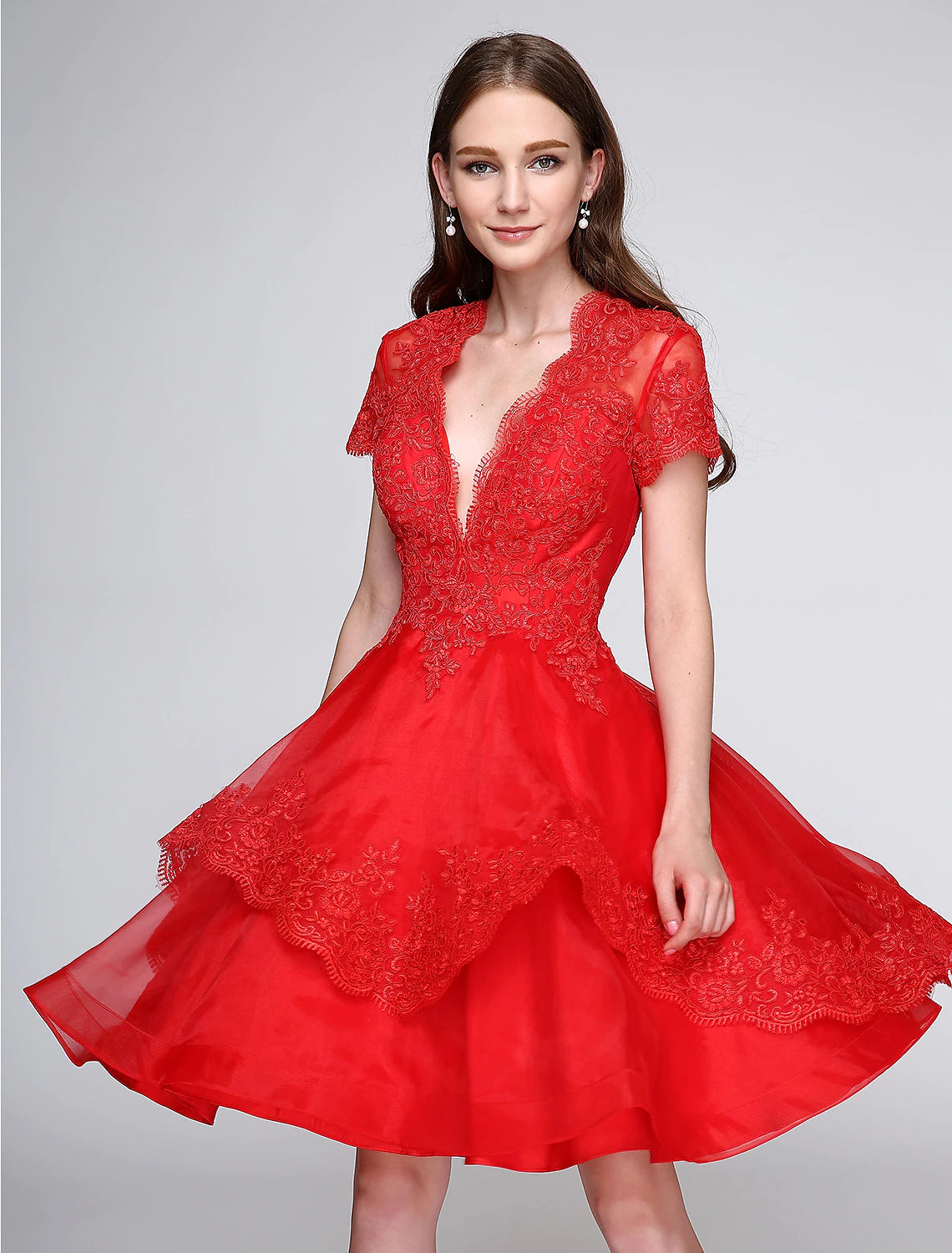 Cute ball gown cocktail dress with plunging neck, short sleeves, organza, and appliques.