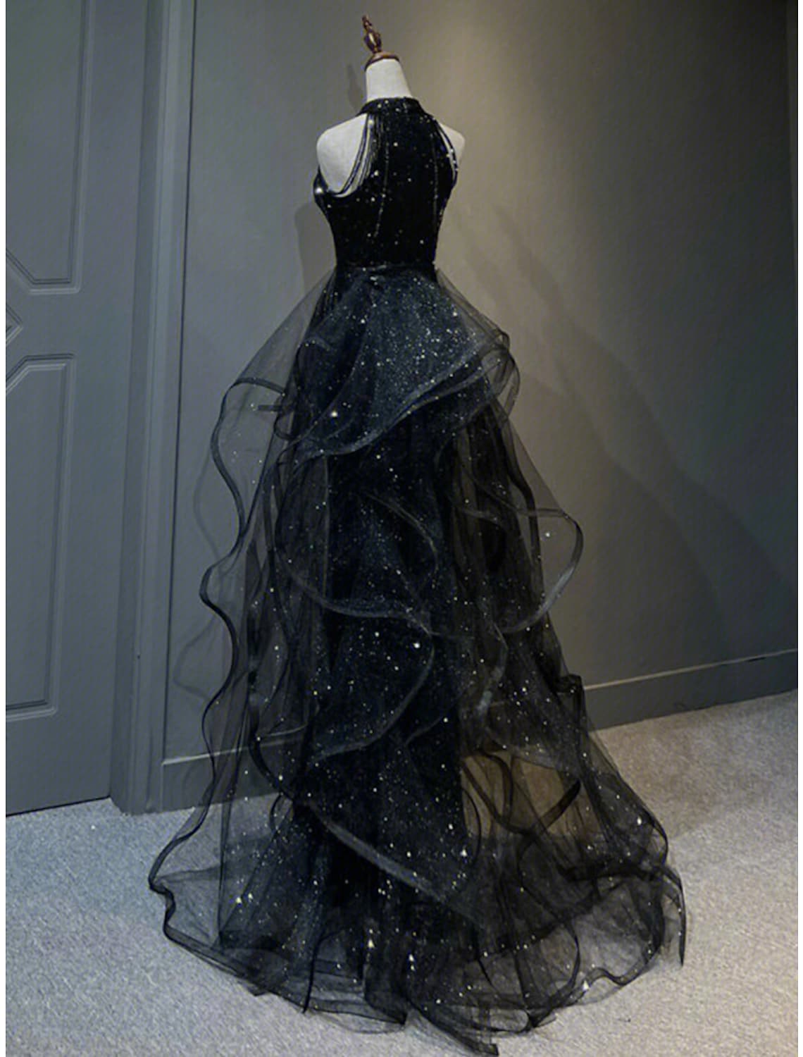 Side profile of the A-line prom dress, showcasing ruffles and sparkling fabric.