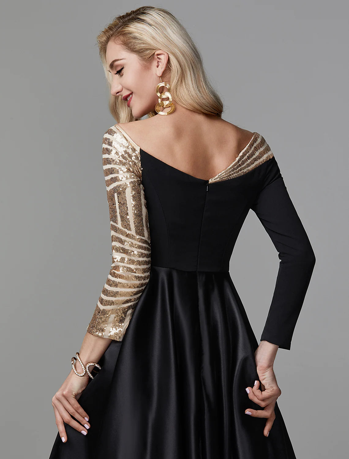 Back view of an elegant A-Line off-shoulder short sleeve glitter tulle prom dress.