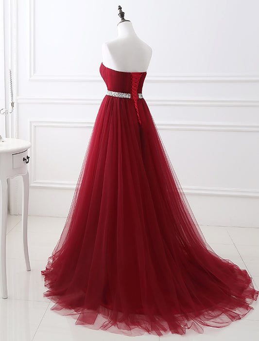 Elegant A-Line Strapless Blush Prom Quinceanera Dress with Chapel Train and Crystals.
