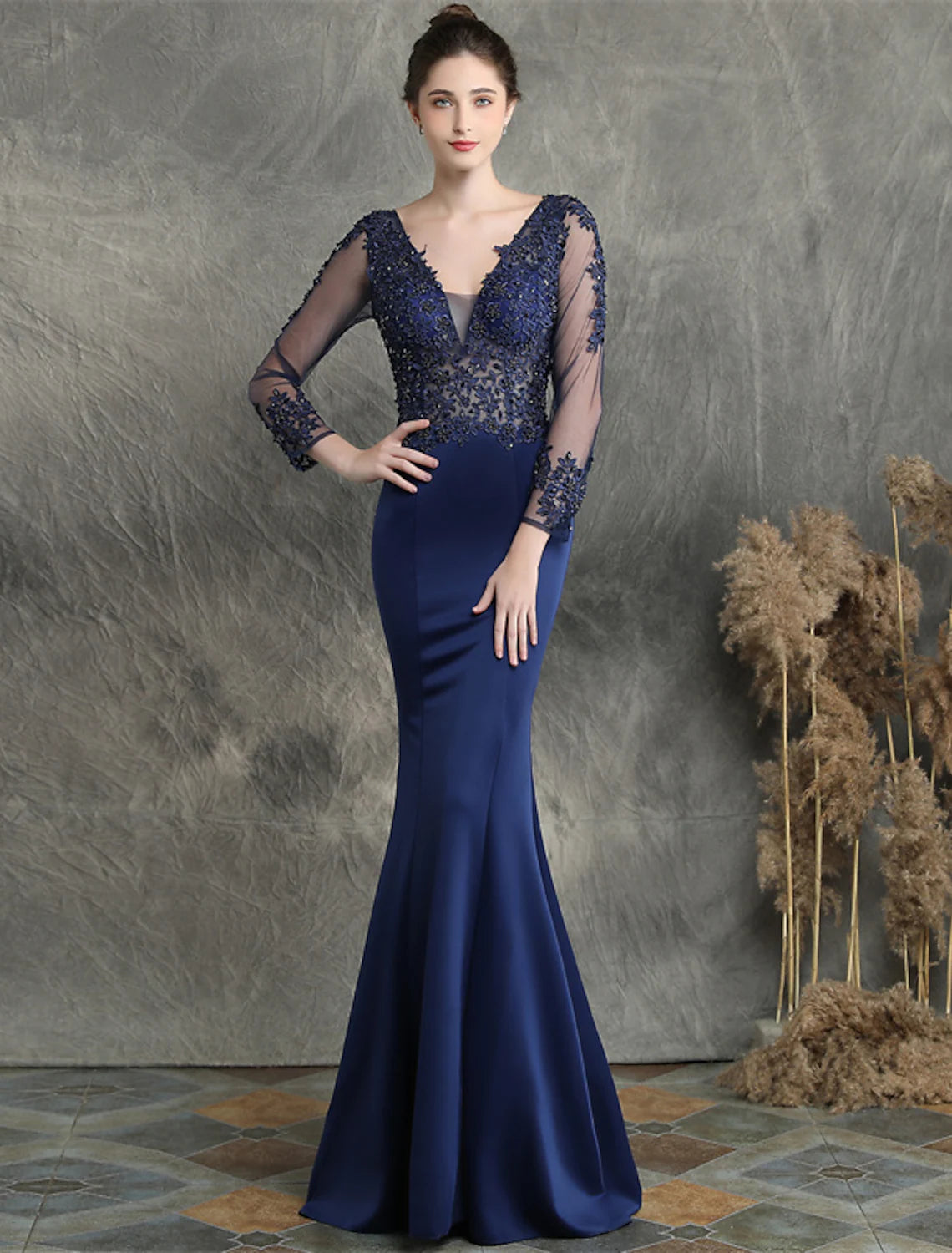 Mermaid prom dress with V-neck, long sleeves, and intricate beading details.