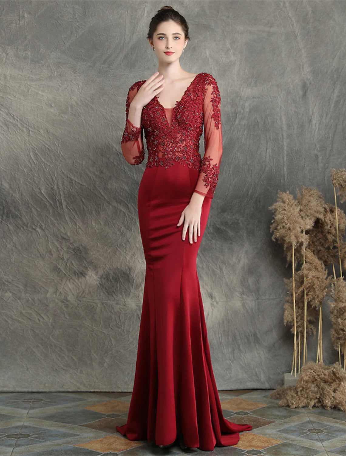 Formal mermaid gown featuring a V-neck, long sleeves, and elegant sweep train.