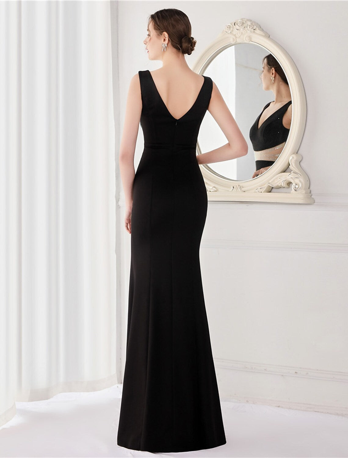 Front view of a mermaid V-neck evening gown showcasing the high slit.