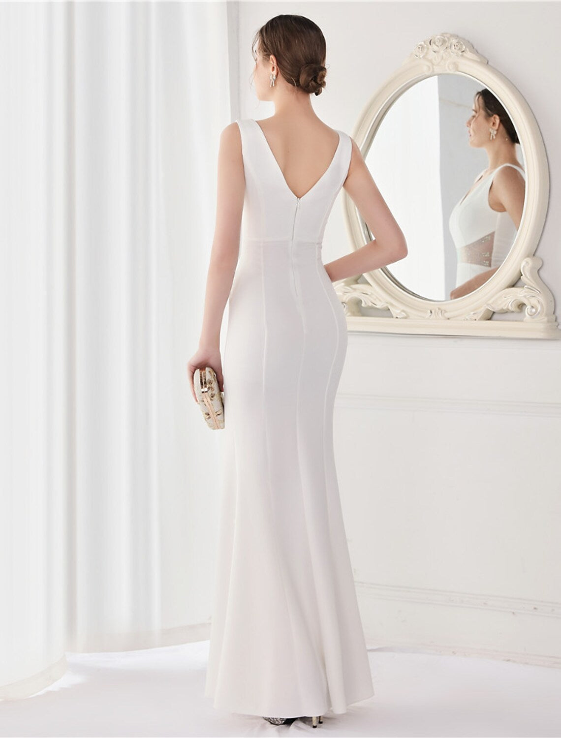 Full length view of a woman wearing the elegant mermaid V-neck evening gown.