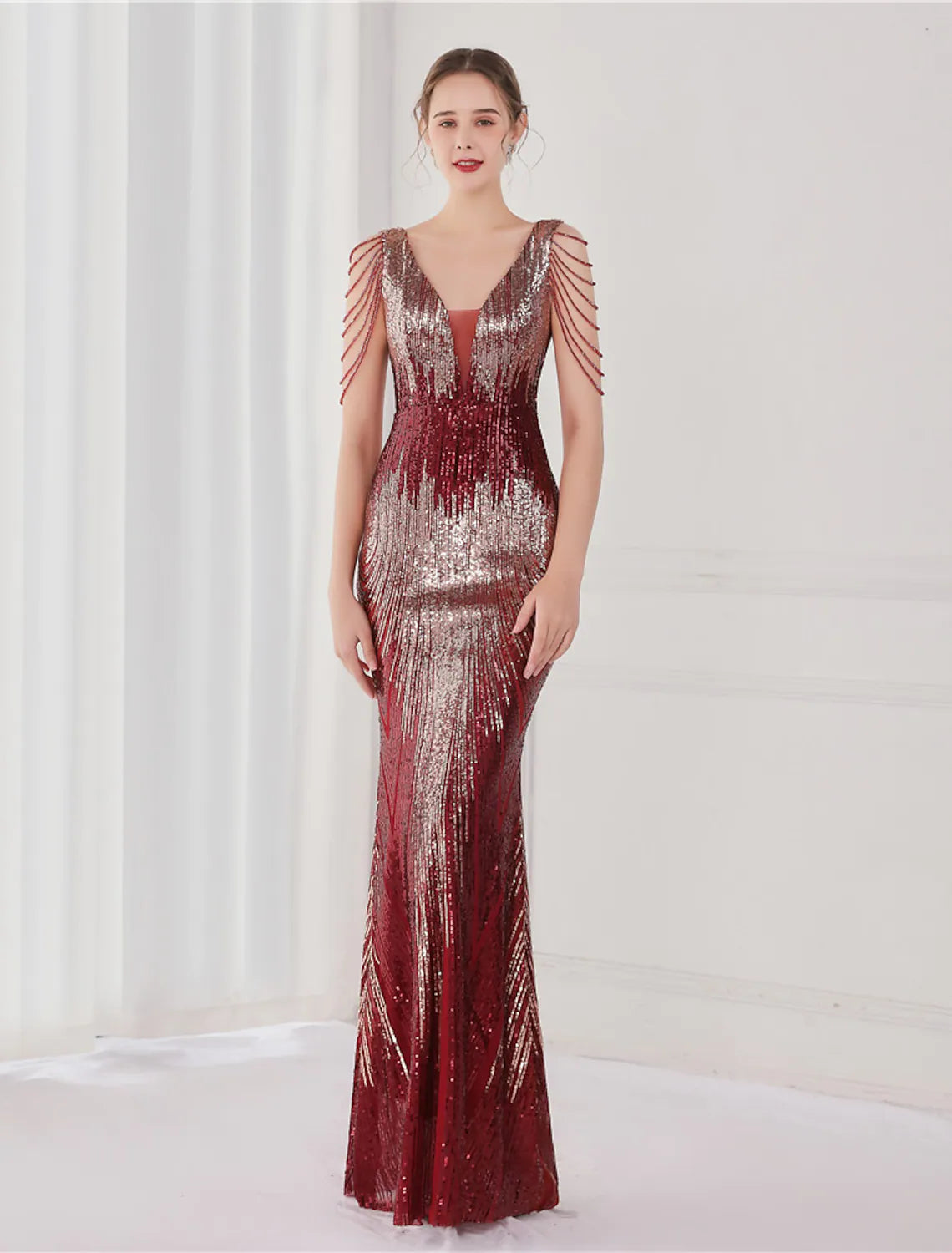 Side profile of the elegant sequined trumpet dress.