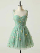 Model wearing a charming A-line floral embroidered tulle short mini homecoming dress.