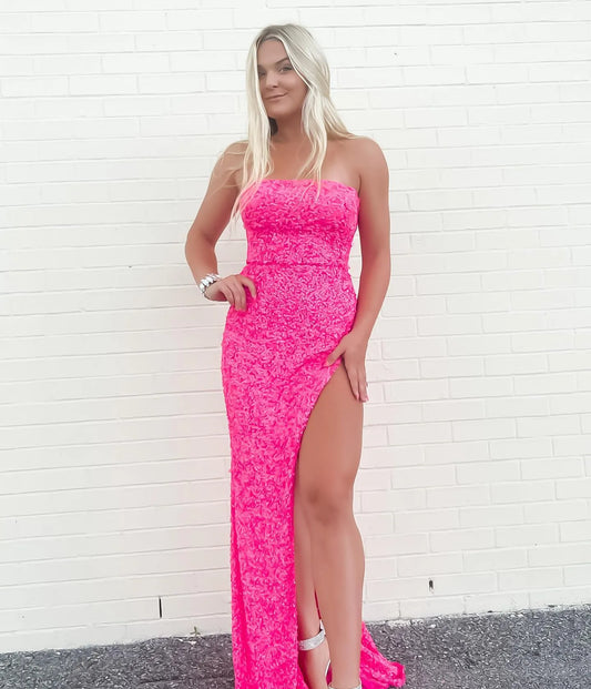 Dazzling hot pink sequin mermaid prom dress with strapless neckline and high slit.