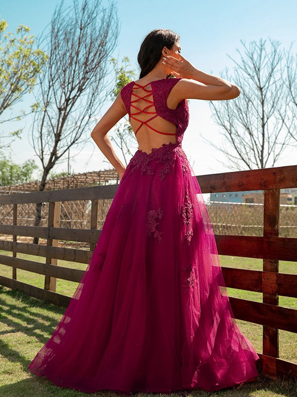 Criss-cross back detail on a floor-length floral lace dress.