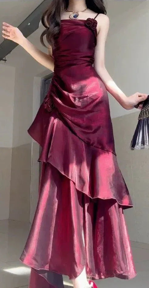 Model wearing an elegant burgundy mermaid prom dress with square neck and spaghetti straps.