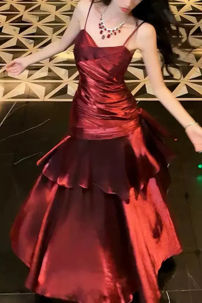 Front view of the elegant burgundy mermaid prom dress, showcasing the V-neck and spaghetti straps.