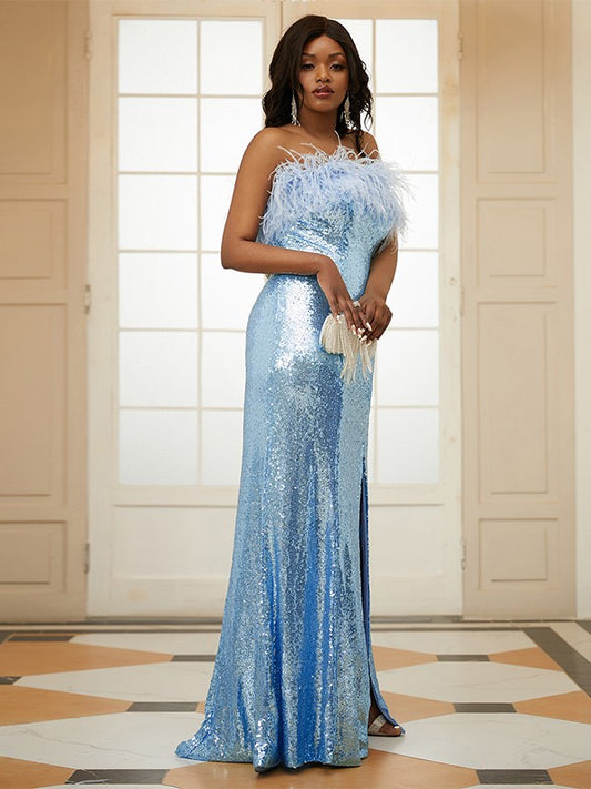 Close-up of the sequined and feather details on the strapless prom dress.