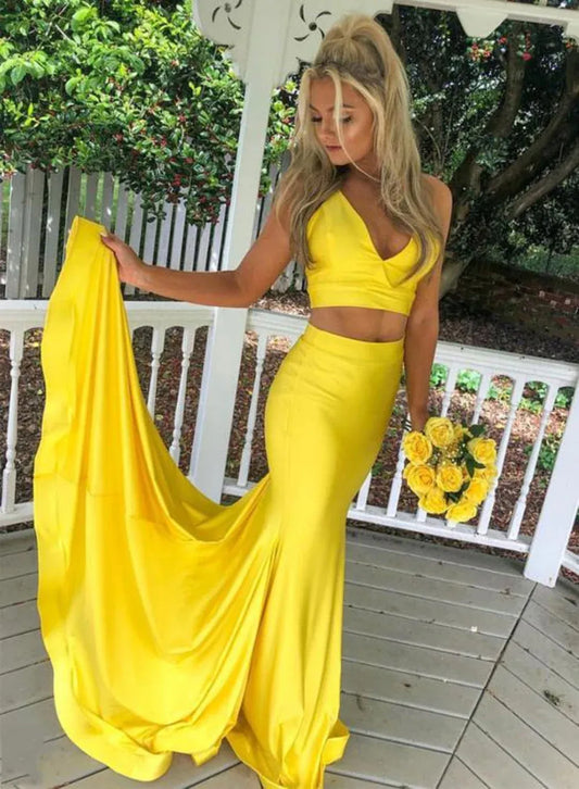 Model wearing an elegant yellow two-piece V-neck satin mermaid prom dress.