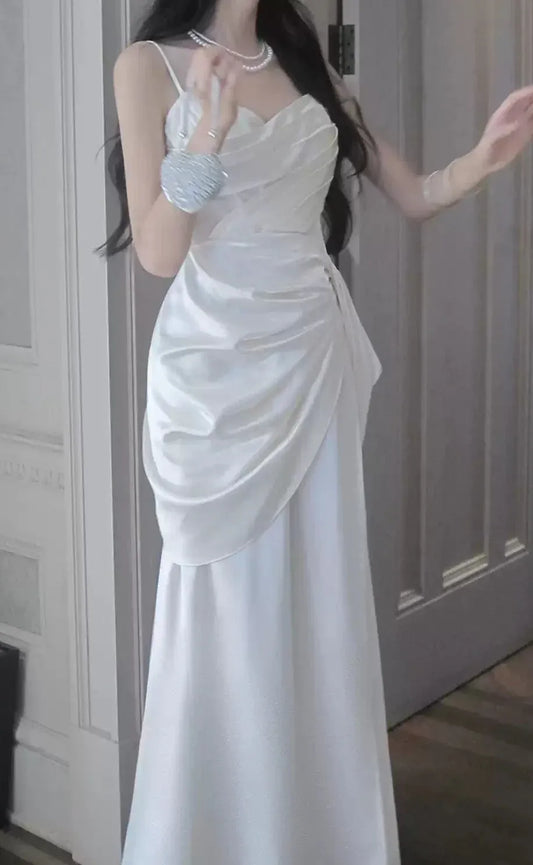 Elegant white satin mermaid prom dress with ruched wrap bodice.