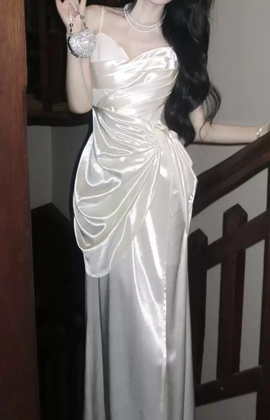 Model wearing a white satin sweetheart spaghetti strap mermaid prom dress.