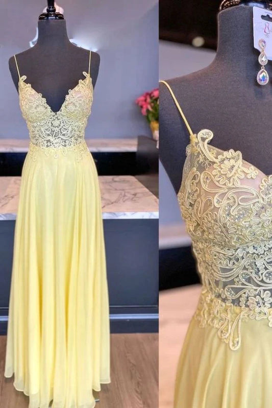 Model wearing an elegant yellow A-line chiffon prom dress with lace applique V-neck and spaghetti straps.
