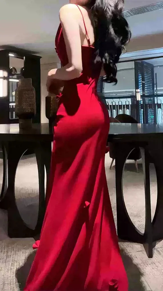 Back view of red high-slit mermaid prom dress with ruched details.