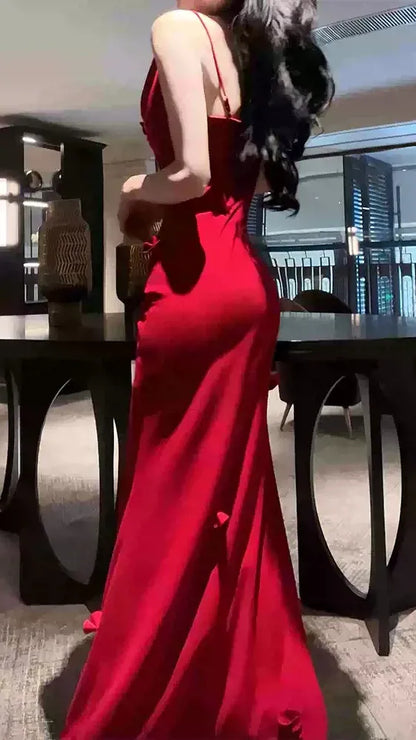 Back view of red high-slit mermaid prom dress with ruched details.
