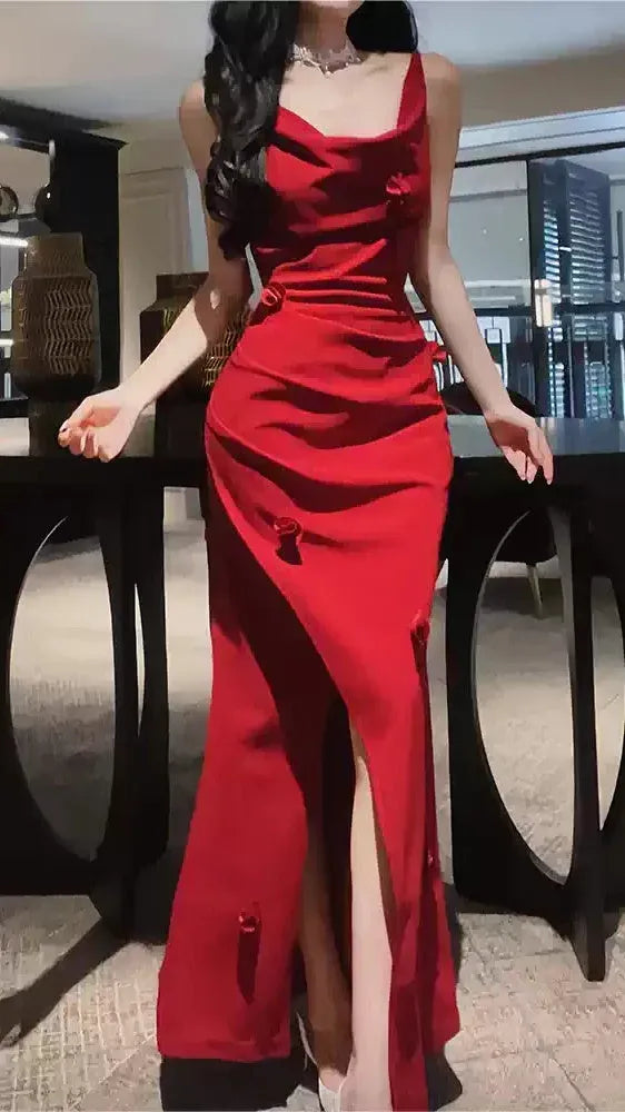 Close-up of 3D bows and ruched bodice on the red mermaid prom dress.