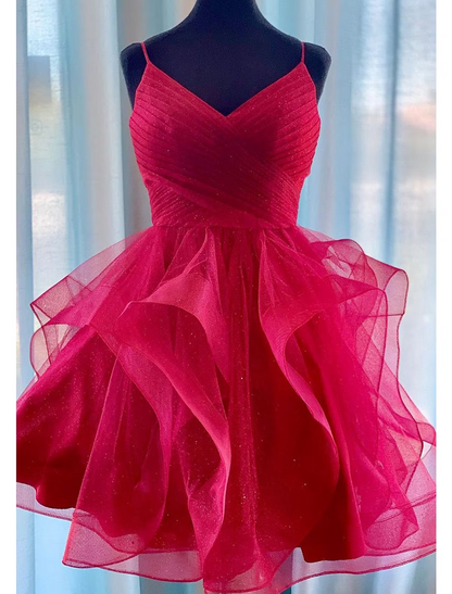 Model wearing a pink glittering short ball gown homecoming dress with spaghetti straps.