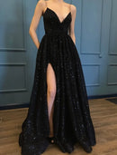 Model wearing a sparkling black A-line V-neck sequin prom dress with spaghetti straps, a high slit, and floor-length hem.