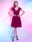 Model in a light pink A-line sweetheart short sleeve chiffon homecoming dress with draping.