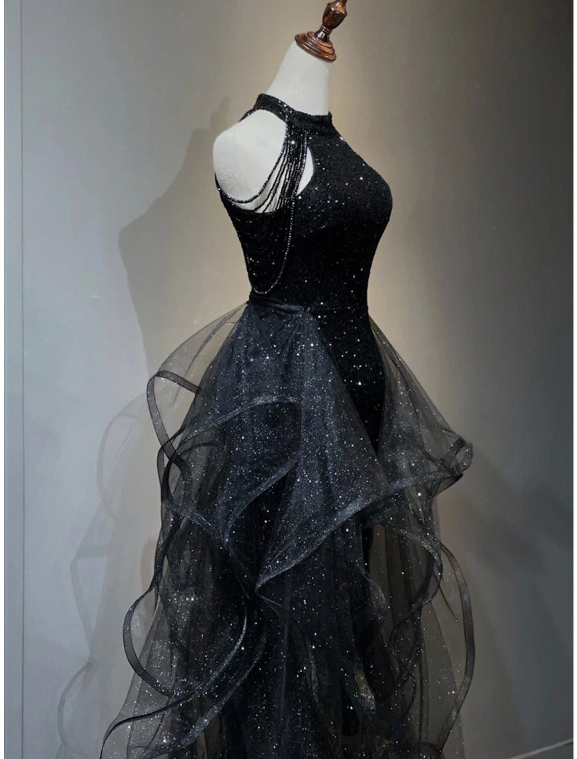 Back view of the A-line sequined prom dress, highlighting the sweep train.