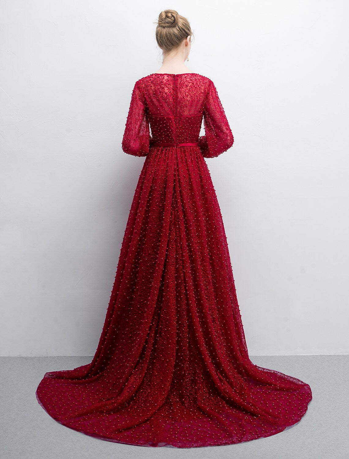 Luxurious A-line evening gown featuring a boat neck and long lace sleeves.