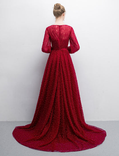 Luxurious A-line evening gown featuring a boat neck and long lace sleeves.