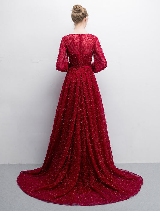 Luxurious A-line evening gown featuring a boat neck and long lace sleeves.