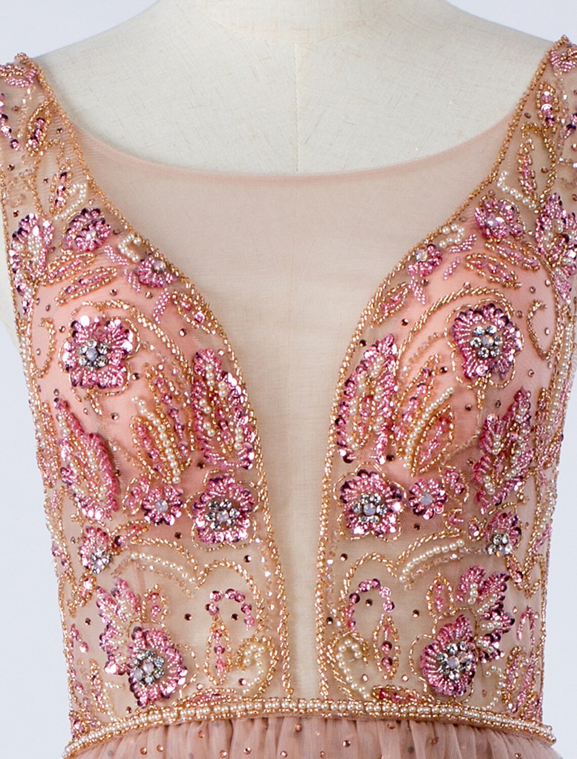 Close-up of the illusion neckline and crystal beading on the silver prom gown.
