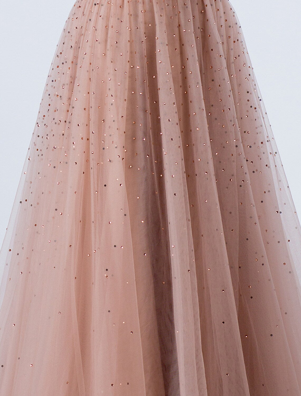 Detail of the backless design and intricate beading on the silver evening gown.