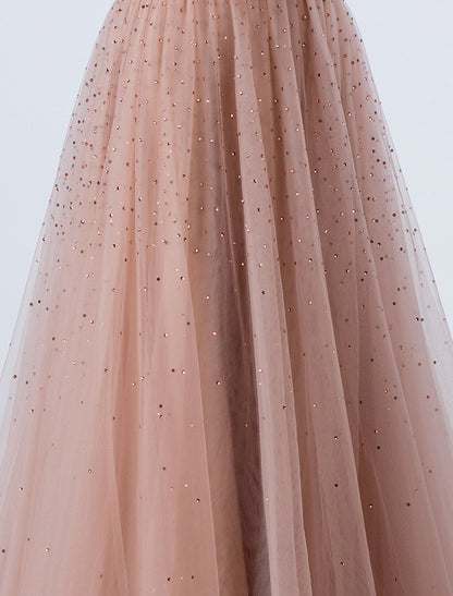 Detail of the backless design and intricate beading on the silver evening gown.