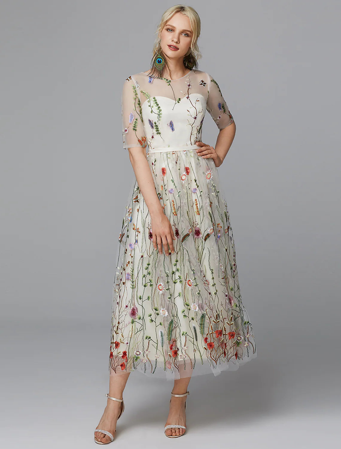 Elegant A-line white tea length dress with lace and half sleeves.
