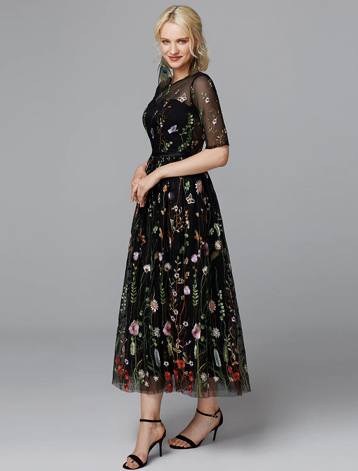 Close-up of the illusion neckline and lace embroidery on the white dress.