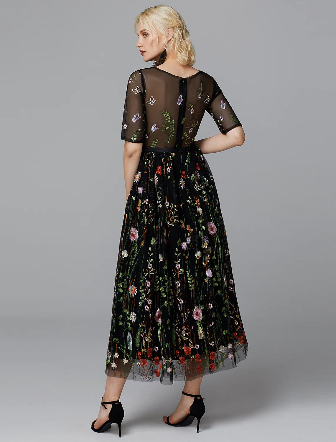 Back view of the white tea length dress with half sleeves.