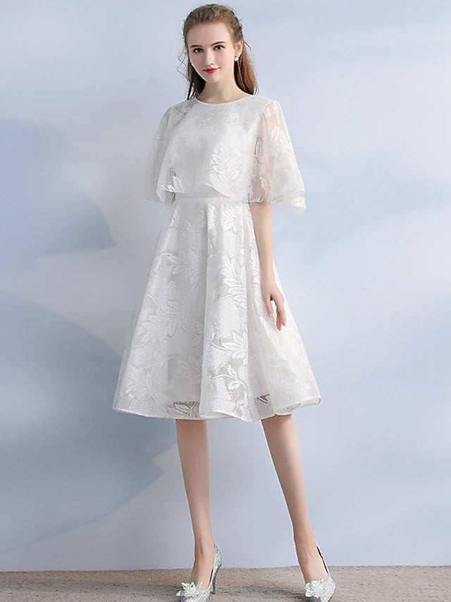 Elegant A-line dark blue cocktail dress with jewel neck and half sleeves, featuring vintage lace detail.