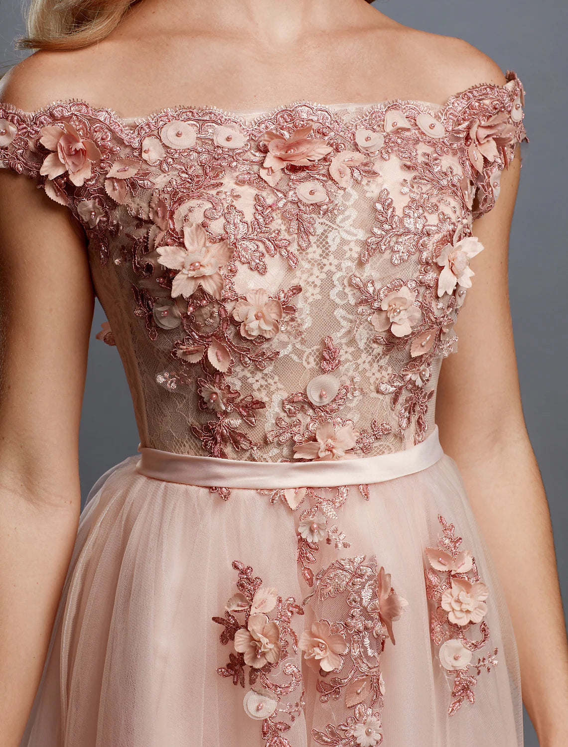 Side view of an elegant A-line off-shoulder floral applique tulle wedding guest dress.