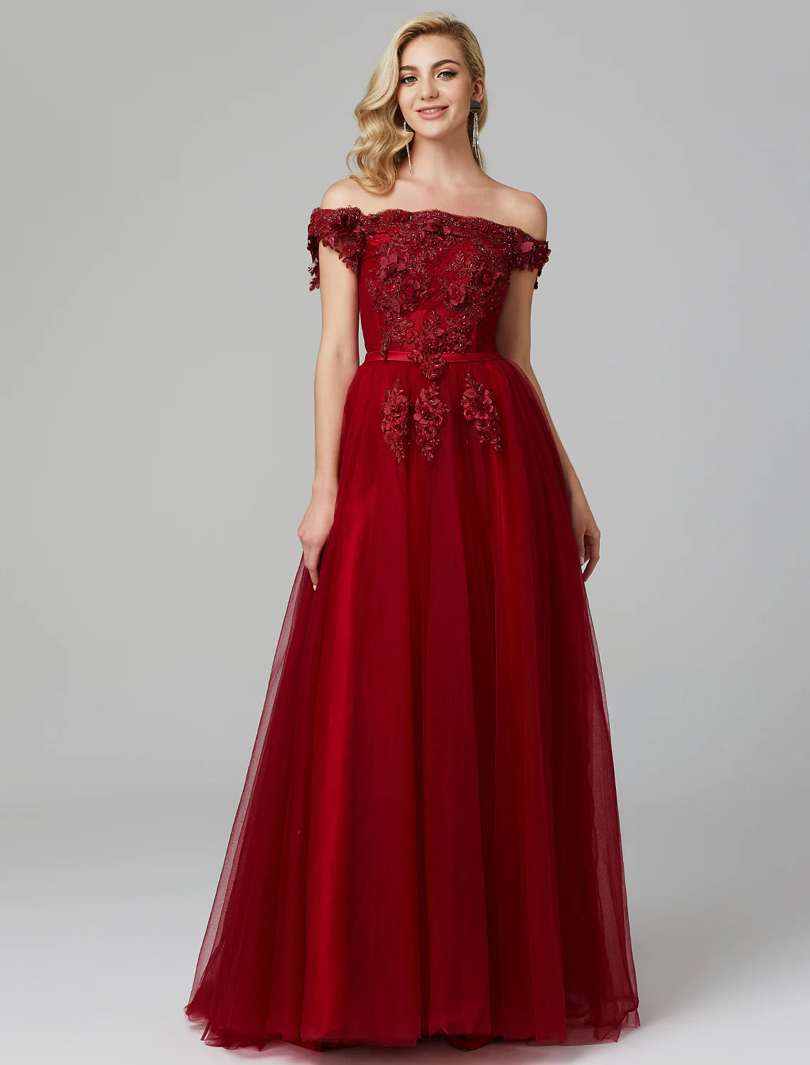 Full length view of the elegant A-line off-shoulder floral applique tulle wedding guest dress, showing movement.