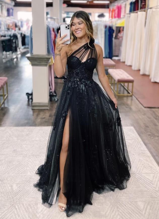 Back view of the one-shoulder prom dress, highlighting the backless design and appliques.
