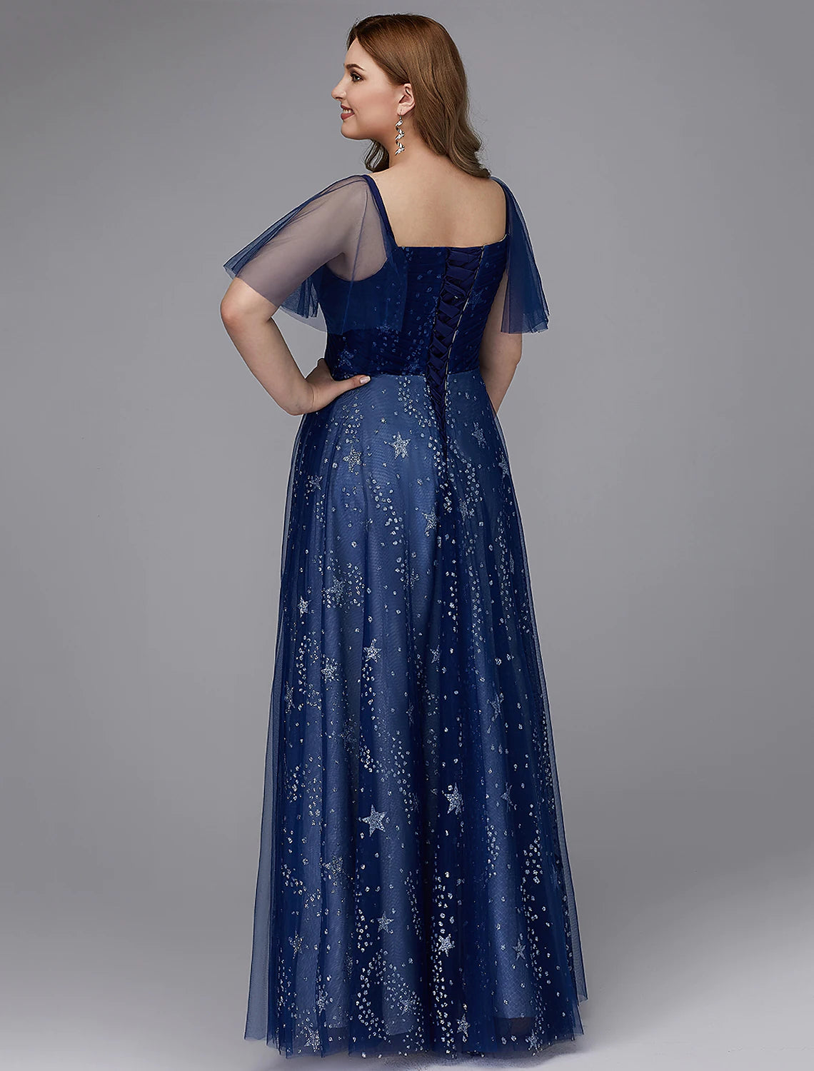 Side view of A-Line plus size prom gown with short sleeves.