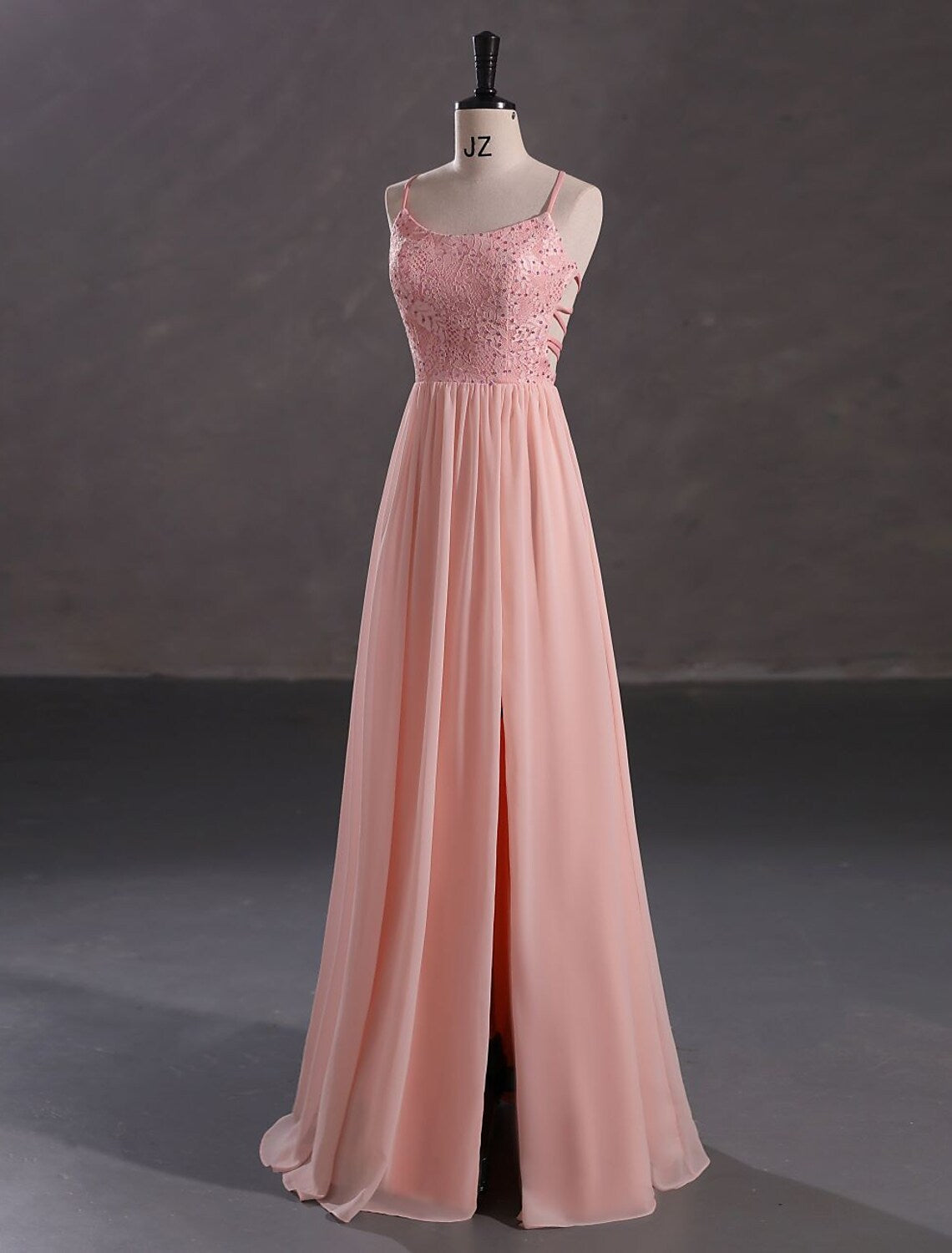 Elegant A-Line spaghetti strap evening gown with sequin slit.