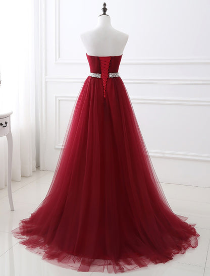 Elegant A-Line Strapless Blush Prom Quinceanera Dress with Chapel Train and Crystals.
