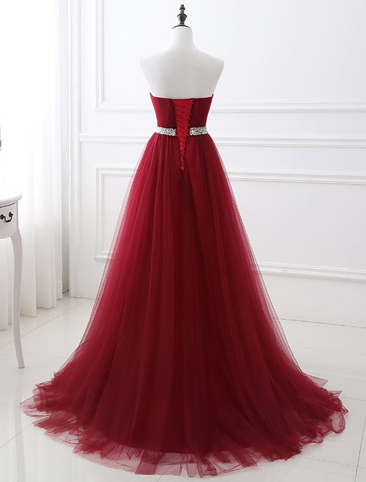 Elegant A-Line Strapless Blush Prom Quinceanera Dress with Chapel Train and Crystals.