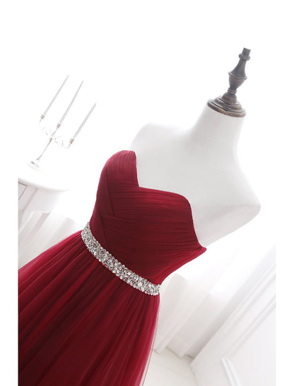 Elegant A-Line Strapless Blush Prom Quinceanera Dress with Chapel Train and Crystals.