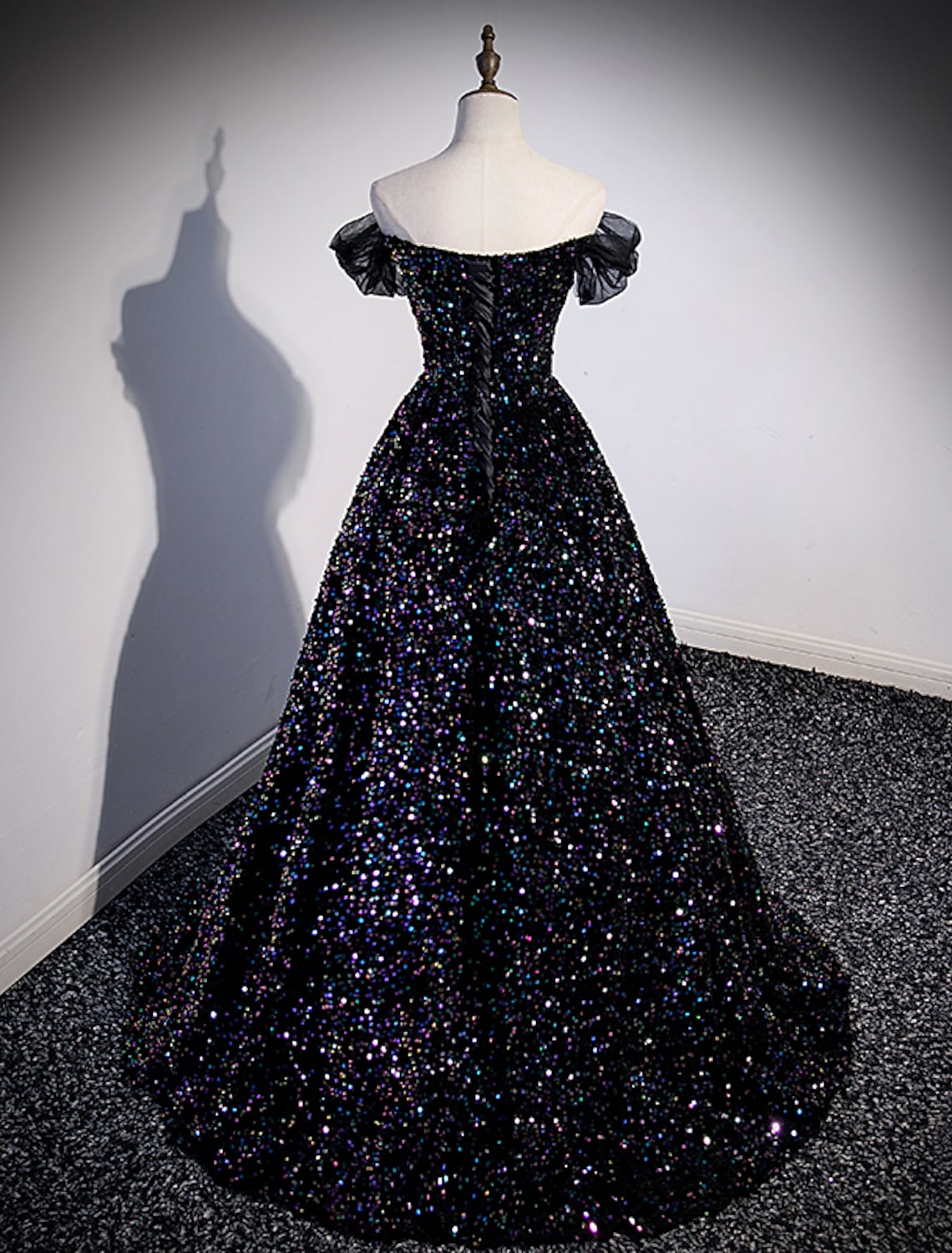 Back view of a sequined ball gown with a graceful court train.