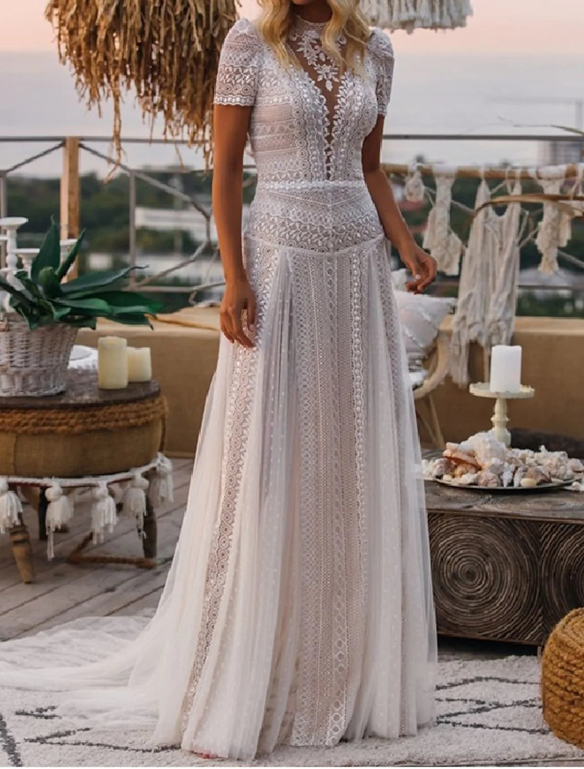 Side view of A-line wedding gown showing court train and lace appliques.