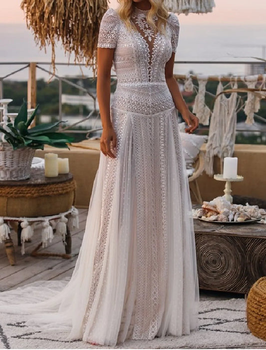 Side view of A-line wedding gown showing court train and lace appliques.