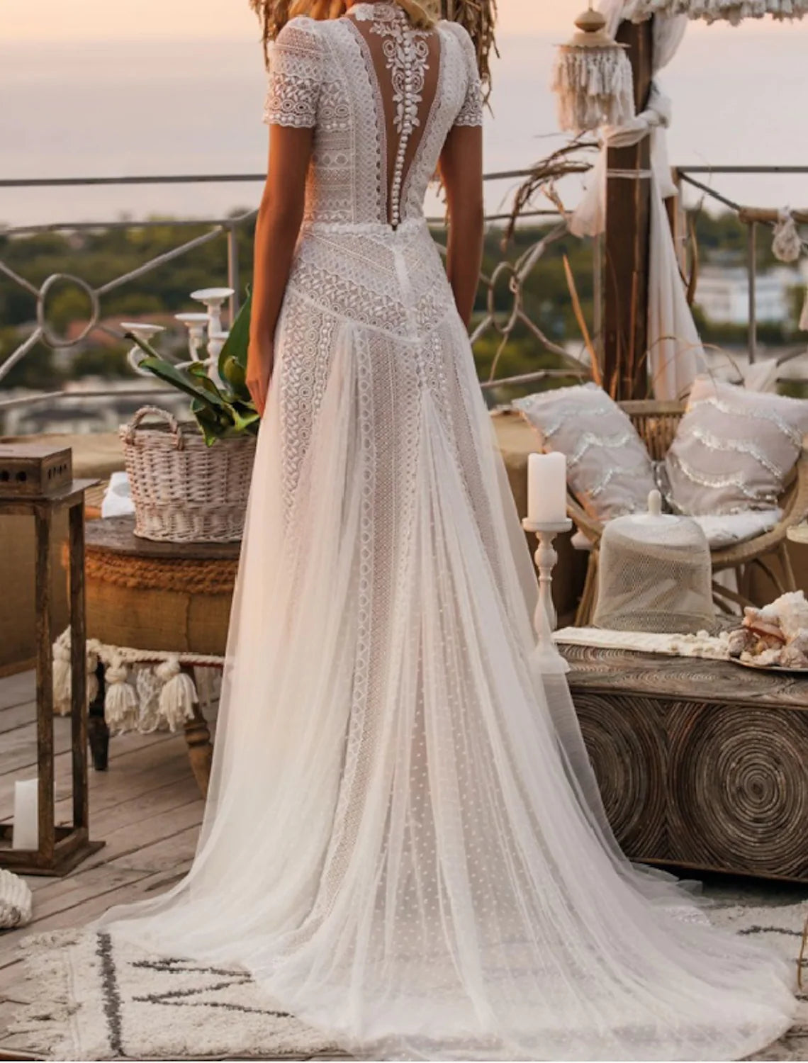 Back view of elegant A-line wedding dress with flowing court train.